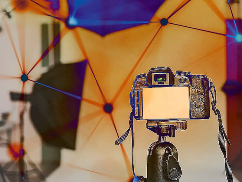 Camera on tripod in a photography studio with lights